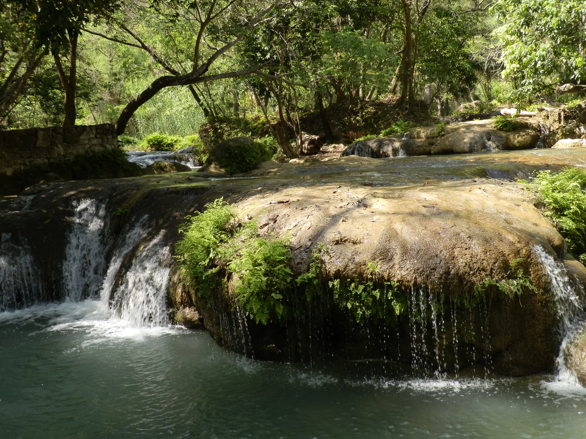 Travertine cascade pools and turquoise river falls